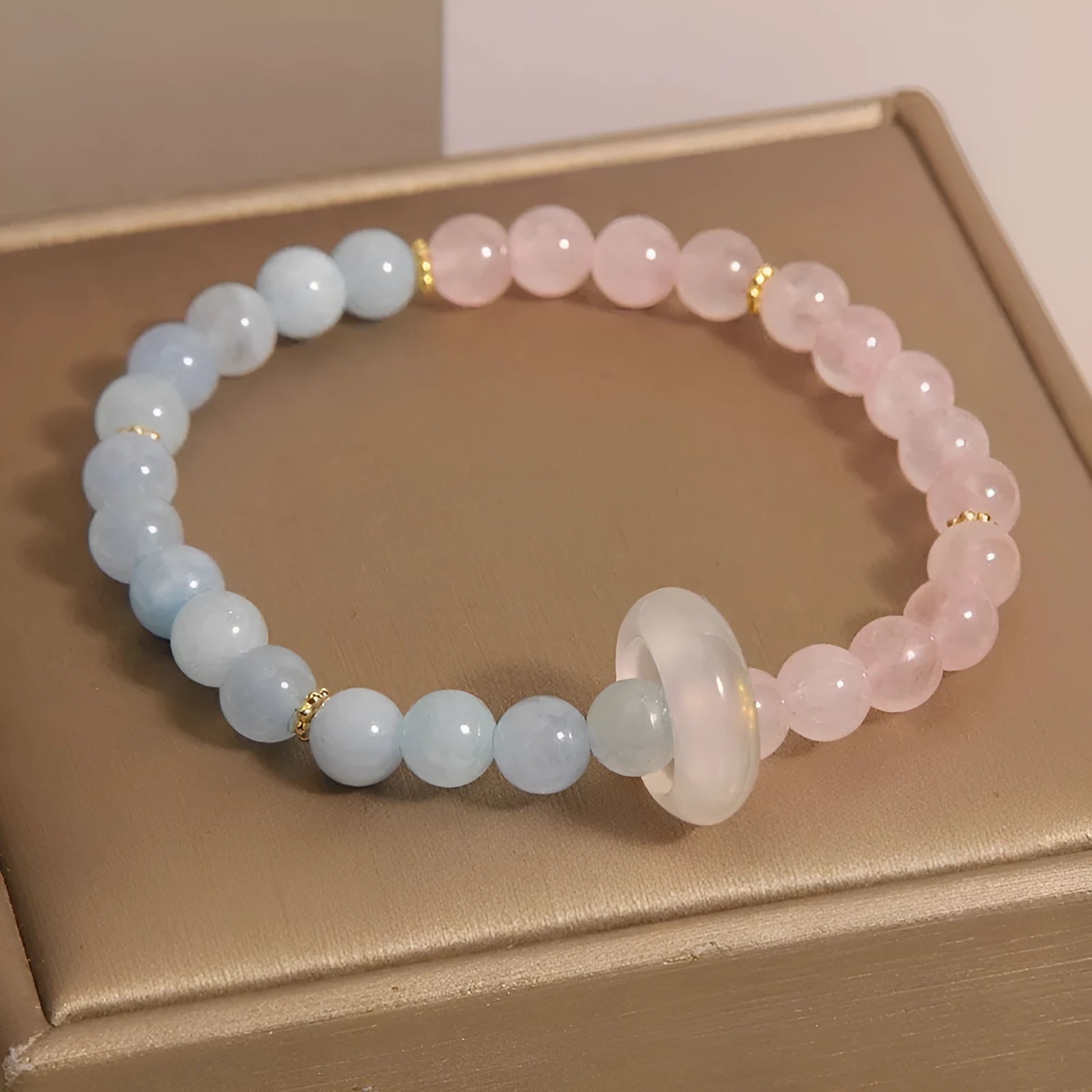 Women's aquamarine crystal bracelet with round geometric beads in mixed materials including natural pink crystal and imitation pearl