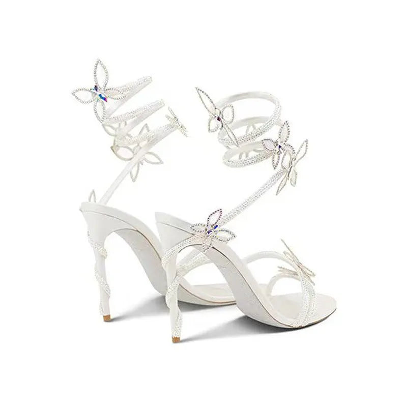 Snake butterfly rhinestone flower stiletto heel Roman sandals in gold with buckle closure and super high heel