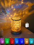 Rotating water ripple effect night light with acrylic body on a solid wood base.