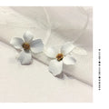 Flower-shaped alloy stud earrings with electroplated pink or white finish and clutch backings