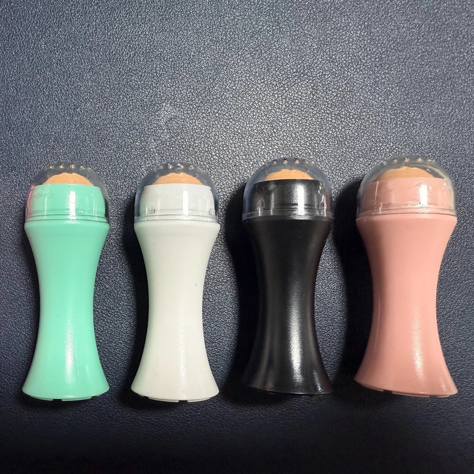 Portable volcanic stone oil control roller in black, green, pink or white for facial skincare