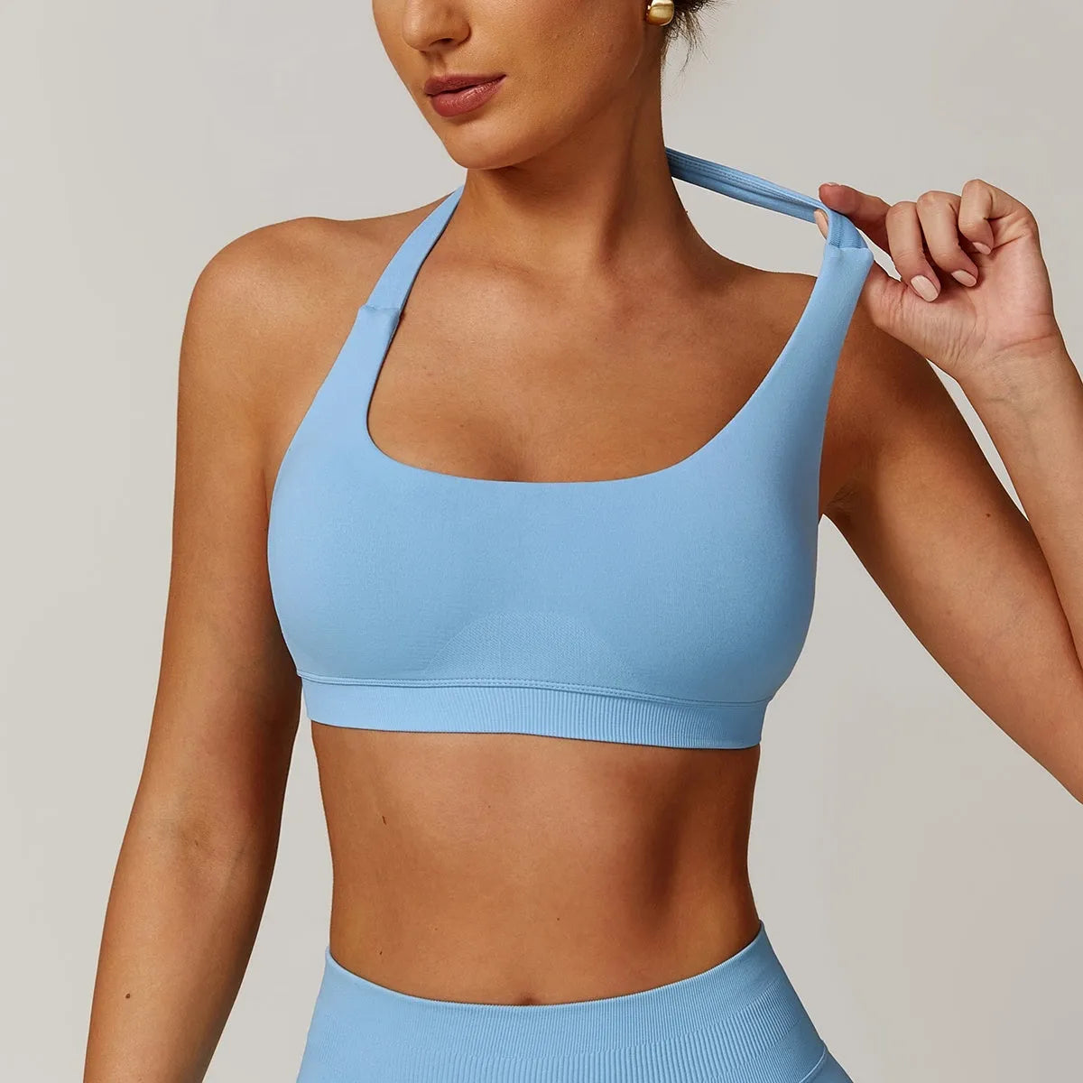 Black women's halter yoga bra with removable padding on a mannequin