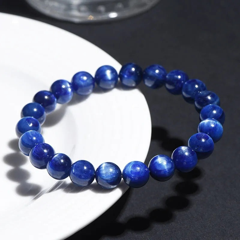 Polished blue crystal bracelet with geometric shapes and ruyi design elements on wrist