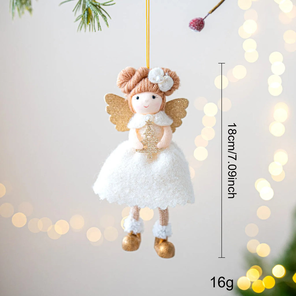 Soft pink cloth Christmas pendant ornament shaped like angel wings on a green branch.