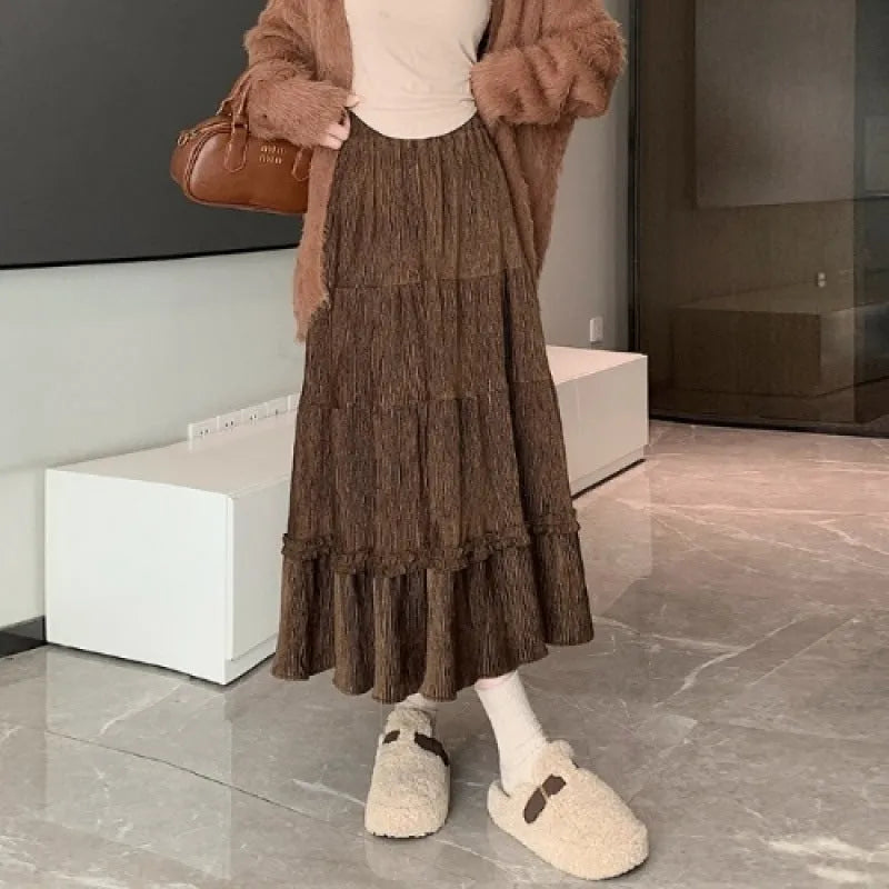 Solid colour corduroy A-line midi skirt with an elastic waistband, shown in a neutral colour.