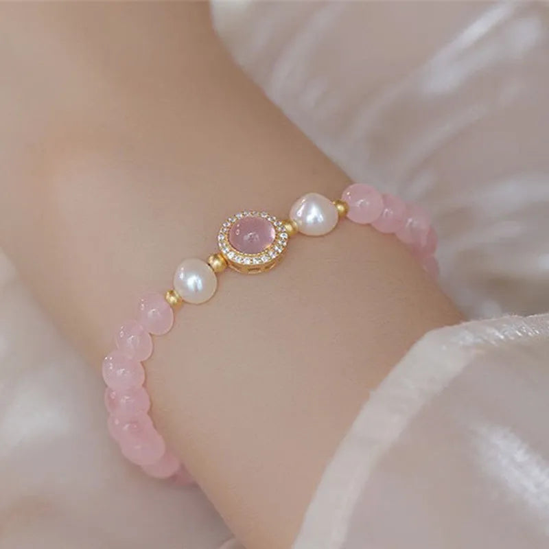 Women's aquamarine crystal bracelet with round geometric beads in mixed materials including natural pink crystal and imitation pearl