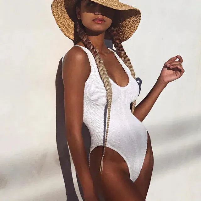 Women's solid colour seersucker one-piece swimsuit with a backless, sleeveless design.