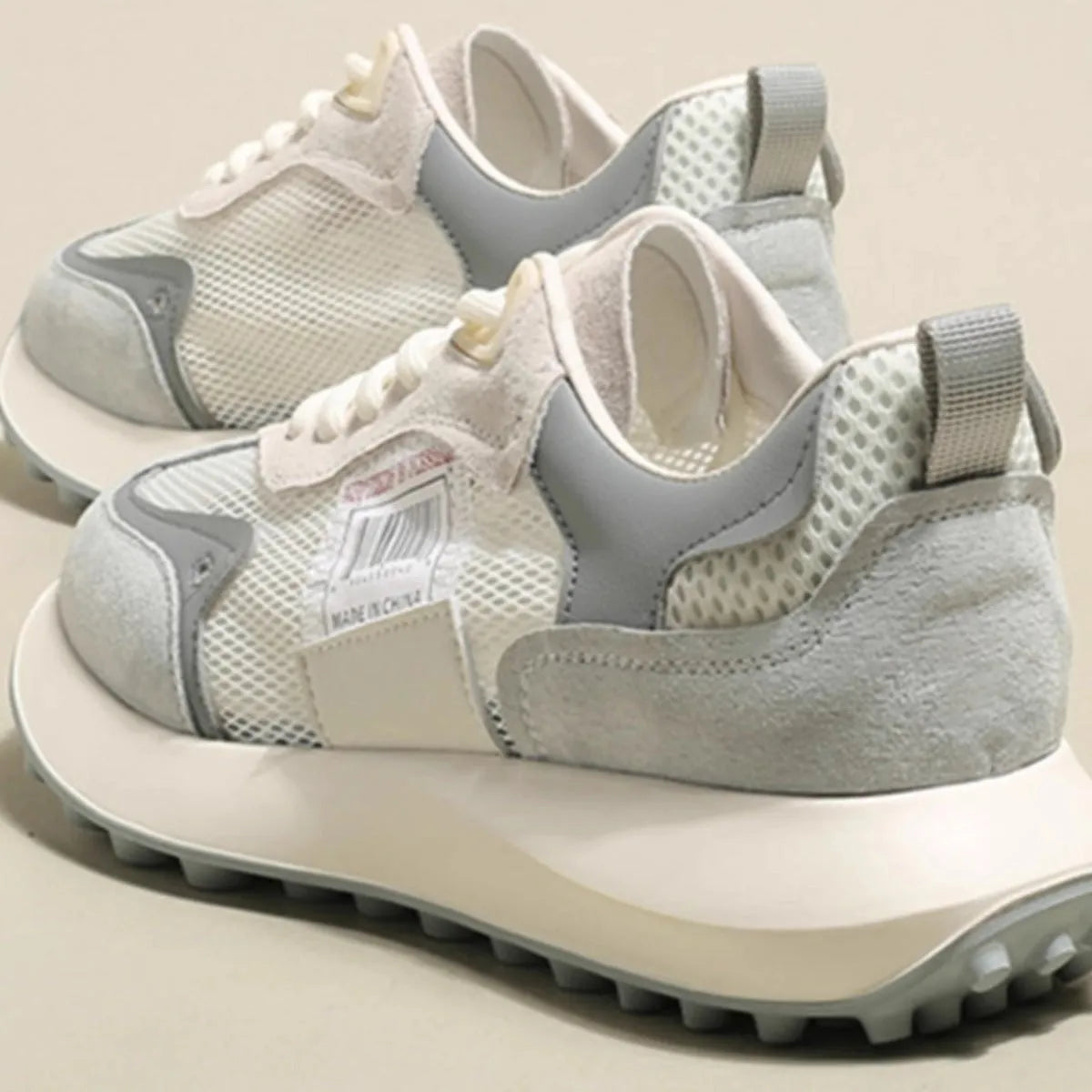 Women's grey retro low-top sneaker with round toe and flat rubber sole on a neutral background.