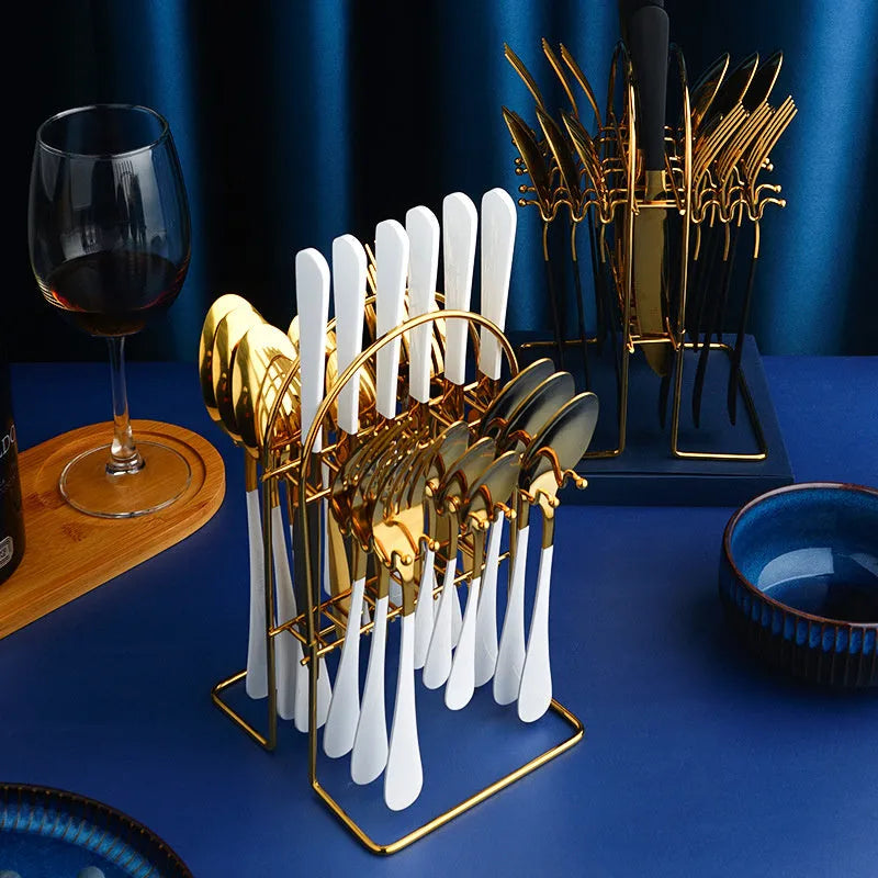 Gold stainless steel 24 piece dinnerware set with storage rack knife fork spoon on white background