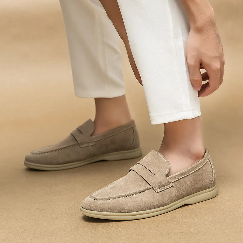 Men's black leather slip-on shoes with round toe and rubber soles shown from side view