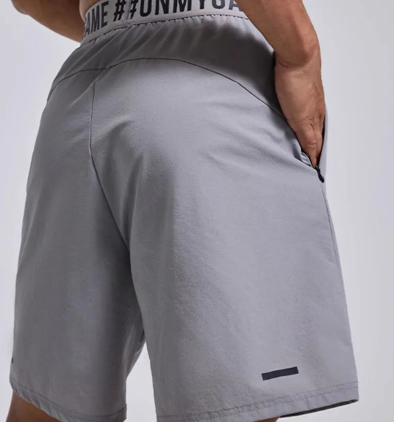 Men's loose black sports shorts with letter print and elastic waist.