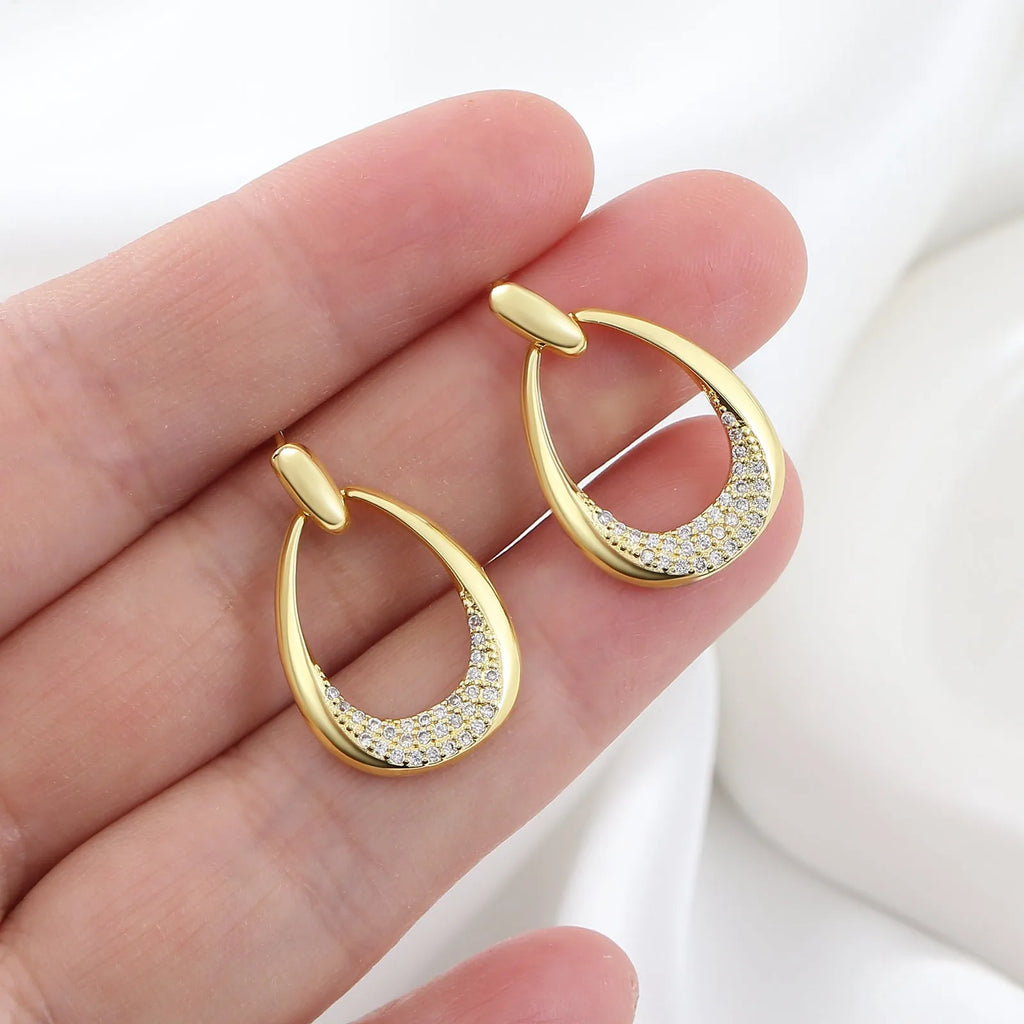 Women's yellow gold geometric drop earrings with oval rings measuring 2.6cm
