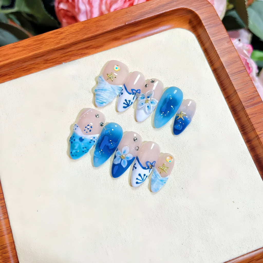 Blue hand-painted carved false nails in summer ice colour with transparent finish