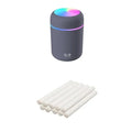 Pink USB desktop humidifier with mood lights and water tank on a wooden desk