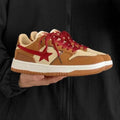 Brown low-top platform sneakers with sequins, lace-up fastening, and rubber sole on light background