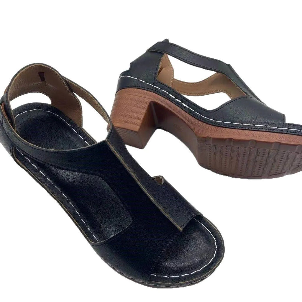 Women's white peep toe wedge sandals with a Roman-style buckle strap and low heel.