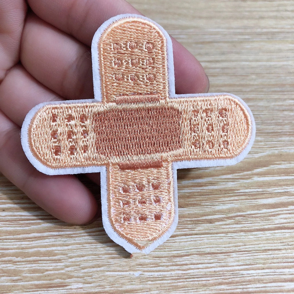 Set of 10 embroidered fabric patches for sewing onto clothing.