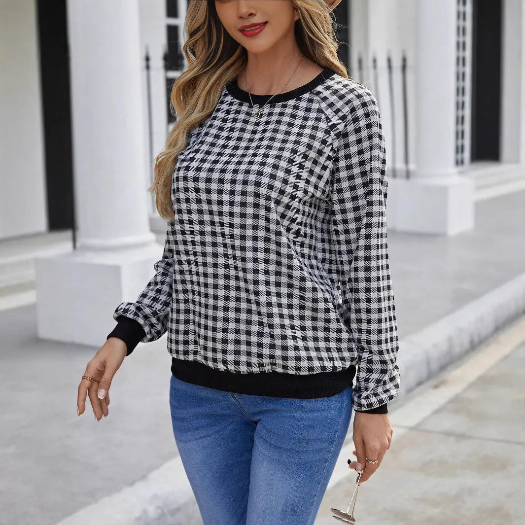 Black long sleeve pullover sweater with printed plaid and stripe pattern design.