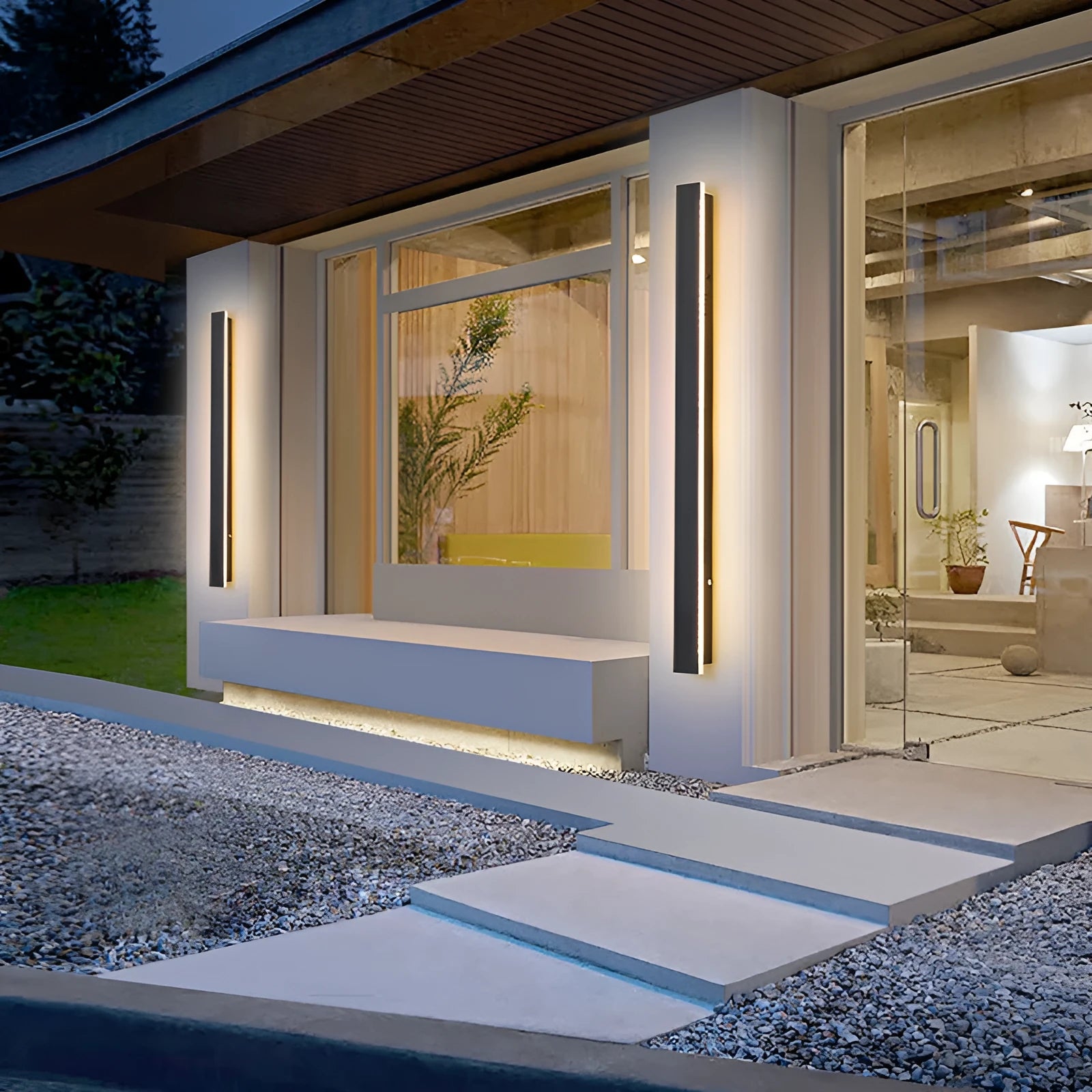 A long, straight outdoor LED wall lamp with a black wrought iron shell, mounted on a brick wall.