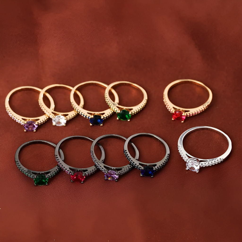 Geometric hexagon design copper zircon ring in various electroplated colours on a size guide.