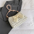 Women's one-shoulder canvas handbag in horizontal square shape with single strap.