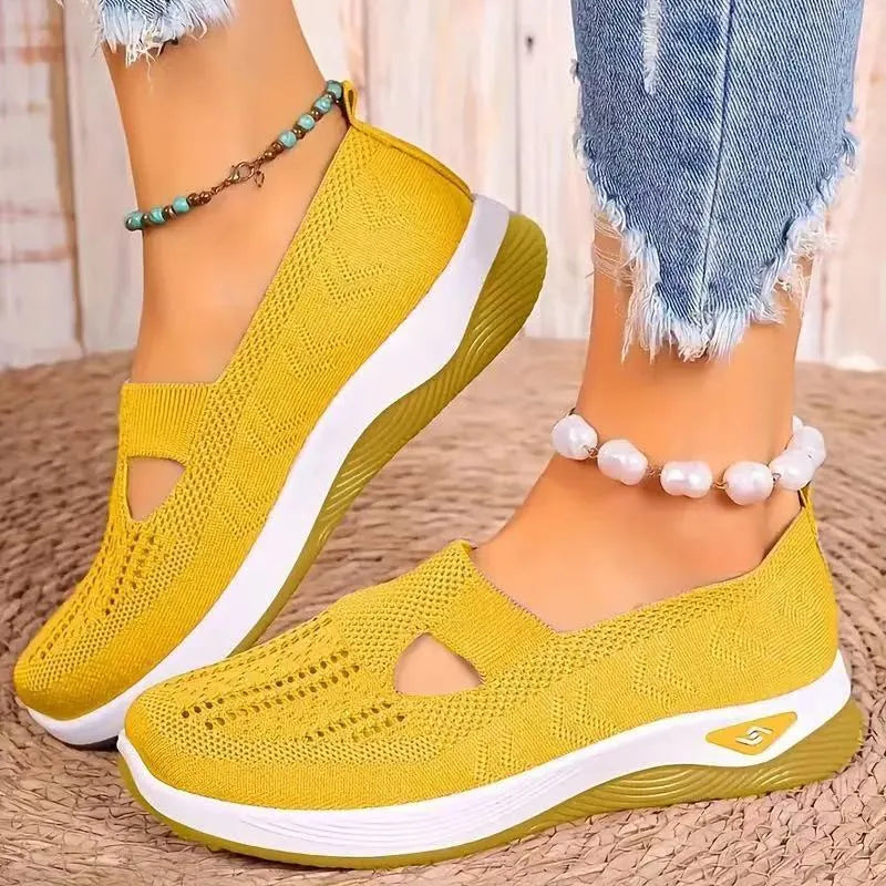 Soft-bottom casual mesh shoes with T-strap in multiple colours on a flat heel and round toe.