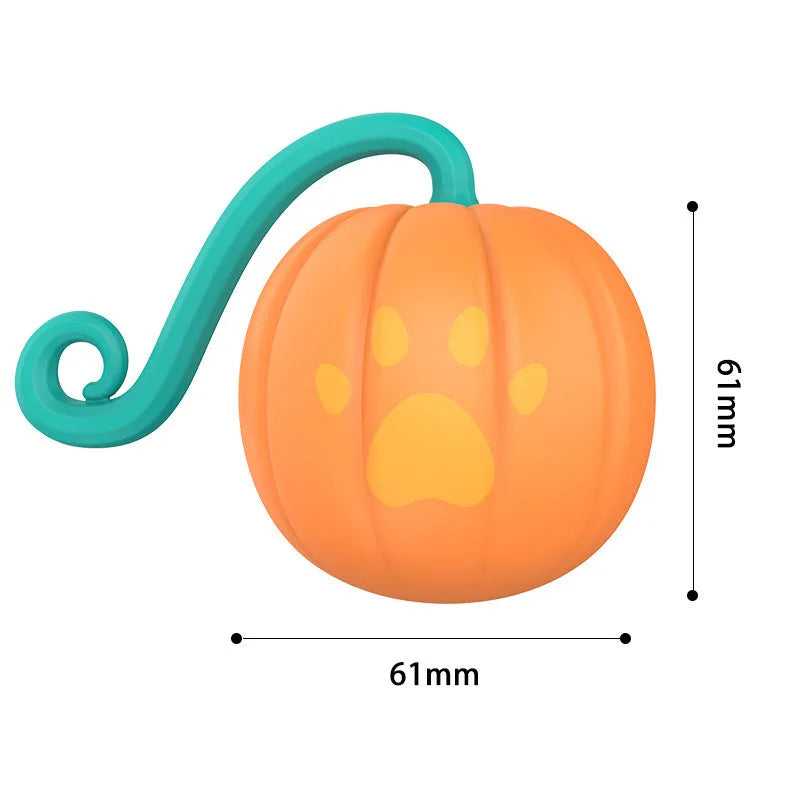 Electric cat toy luminous ball in pumpkin colour on floor