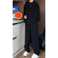 Men's black casual two-piece set with long sleeve polo shirt and matching trousers