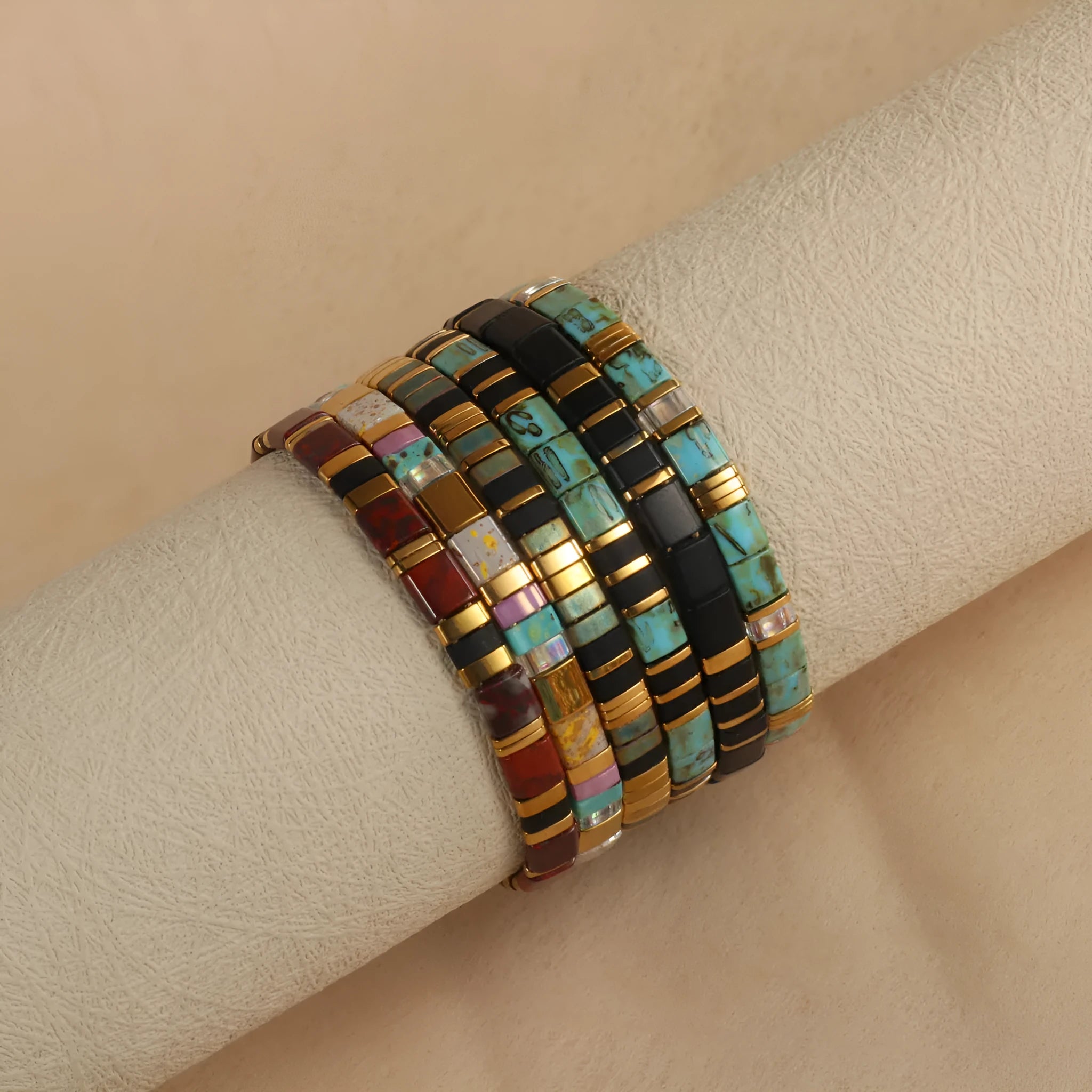 Geometric glass and coloured glaze beaded bracelet in milky white, black, green, blue, or red.