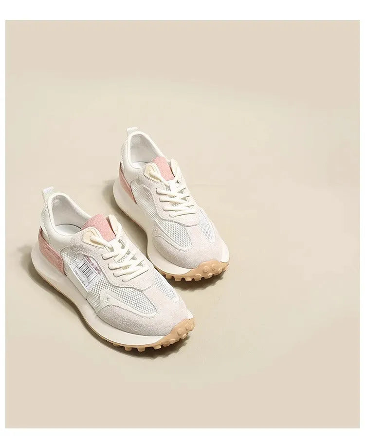 Women's grey retro low-top sneaker with round toe and flat rubber sole on a neutral background.