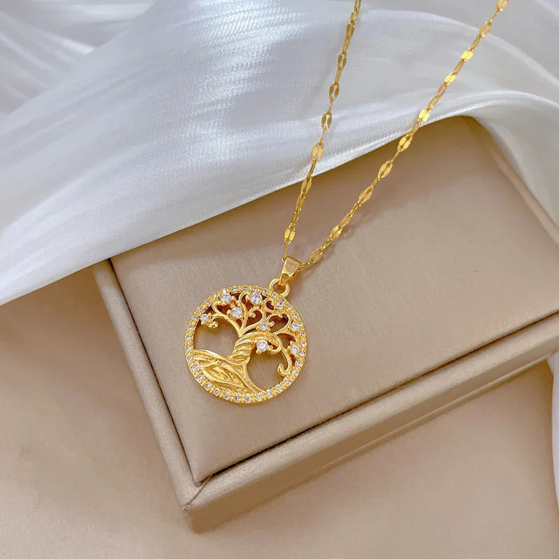 Gold-plated necklace with mother pearl pendant and rhinestone detailing on adjustable lip chain