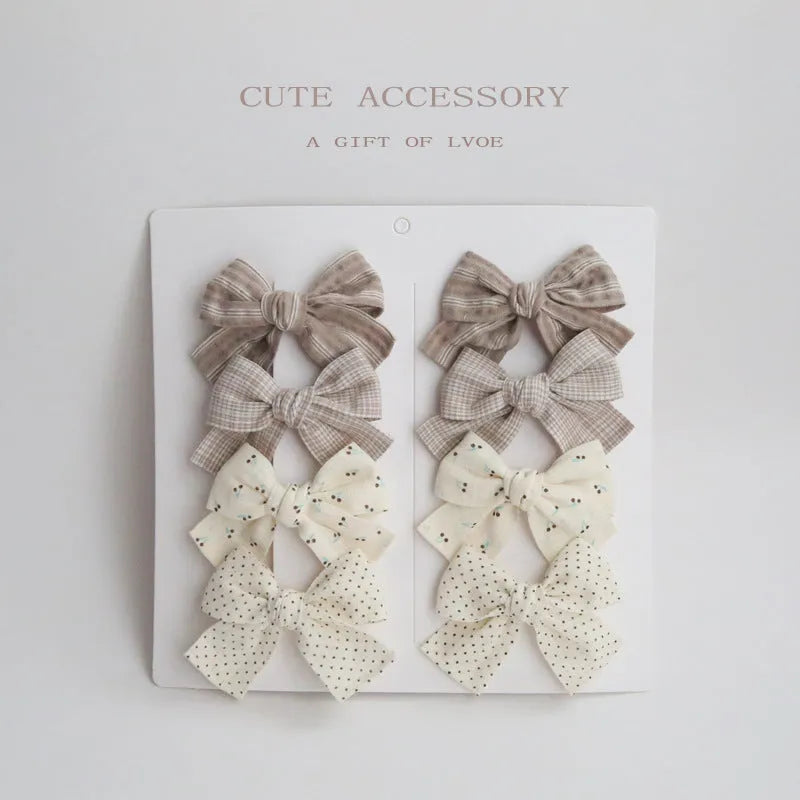 Children's cloth bow hairclips in eight-piece set with dovetail design