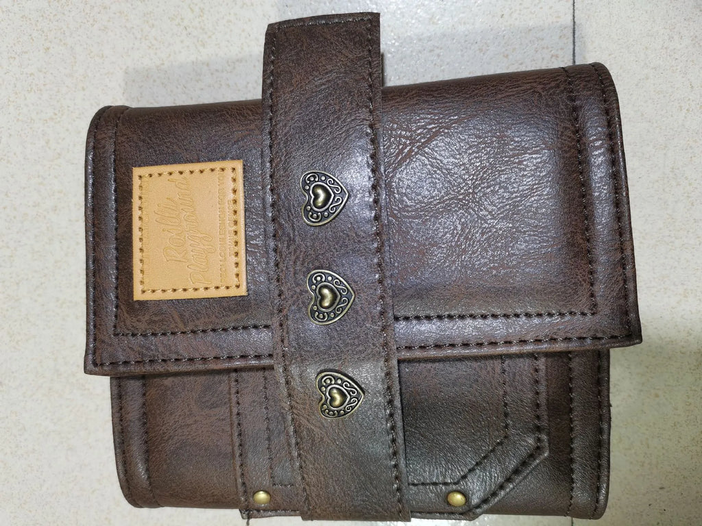 Brown A7 notebook with retro leather buckle closure showing loose-leaf binding