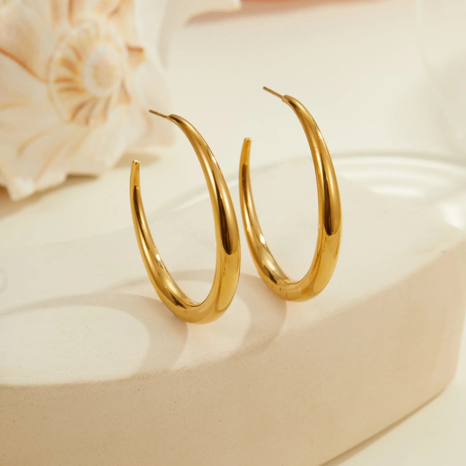 Geometric round titanium steel hoop earrings with 18K gold plating in large and small sizes