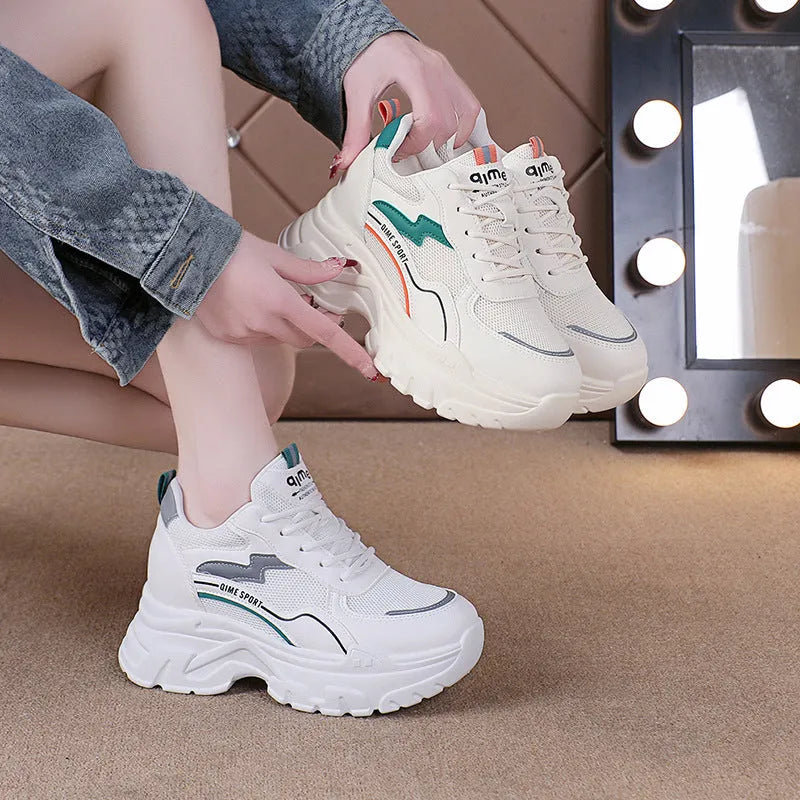 Women's white breathable dad shoes with cross straps and a height-increasing insole, shown with laces.
