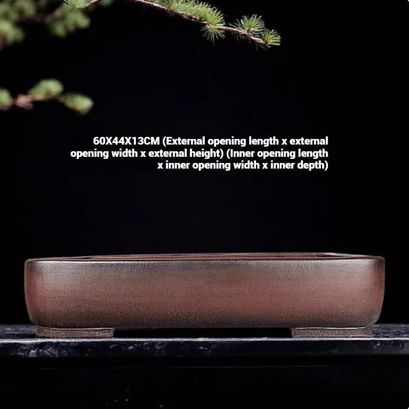 Handmade antique rectangular purple clay flower pot for plants on a tabletop.