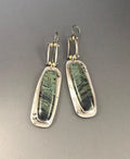 A pair of simple geometric alloy earrings with a two-tone marble pattern finish.