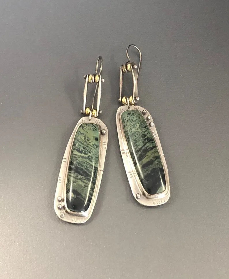A pair of simple geometric alloy earrings with a two-tone marble pattern finish.