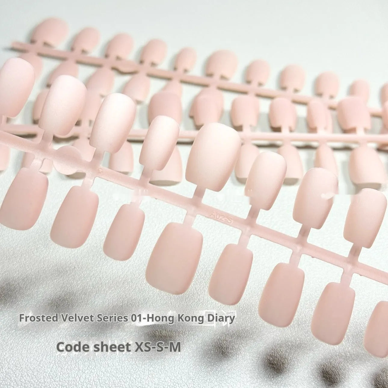 Frosted Velvet Cat's Eye false nail set showing Aurora armour design on short ladder shaped nails in sizes XS, S, and M.