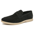 Men's black leather slip-on shoes with round toe and rubber soles shown from side view