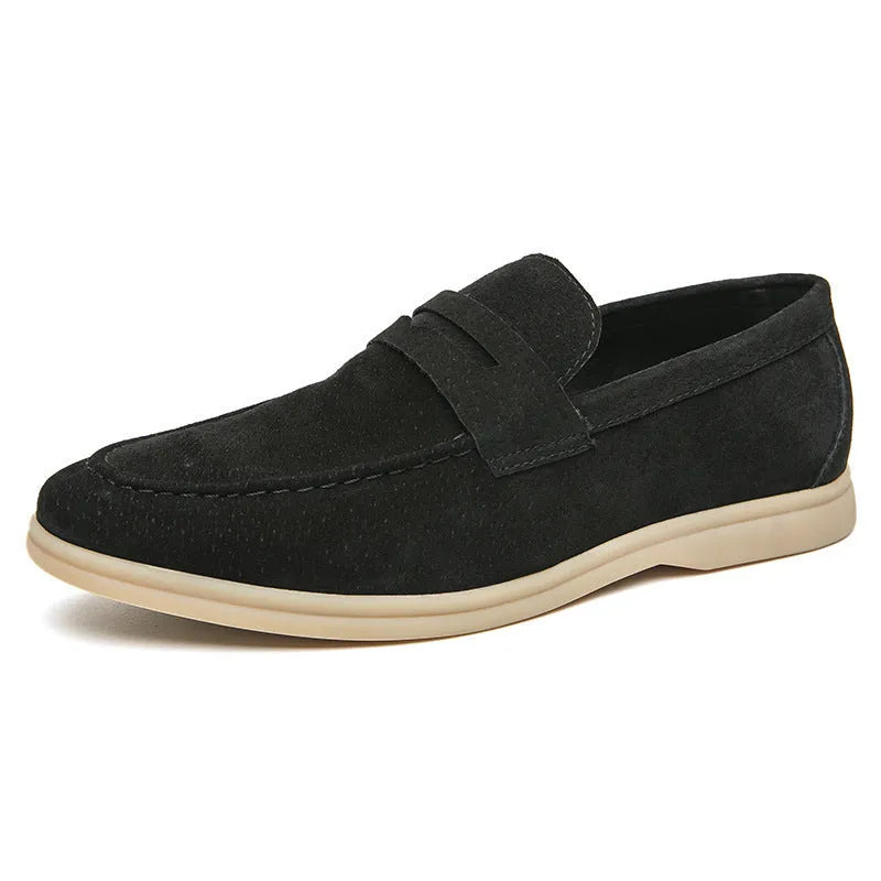 Men's black leather slip-on shoes with round toe and rubber soles shown from side view