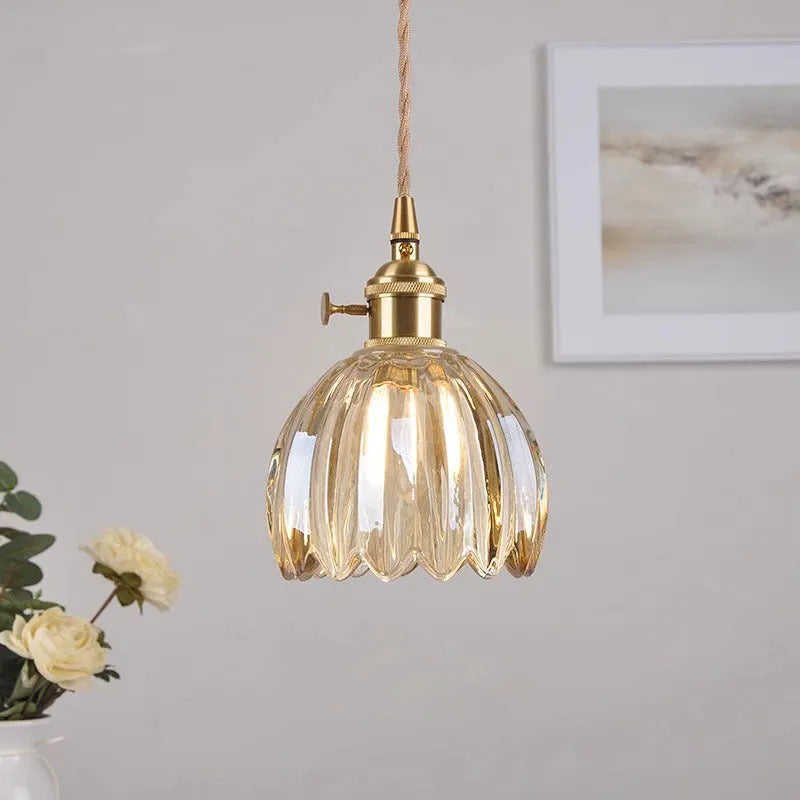 Nordic style bedside chandelier with a glass flower shade in amber, on a white background.