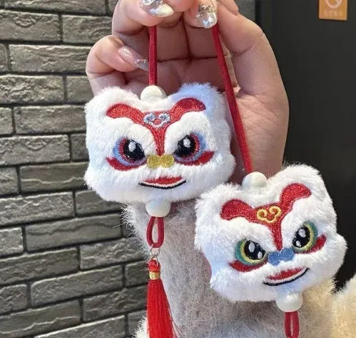 Blue and yellow Chinese style cartoon plush lion keychain ornaments with tassels and a star stone.