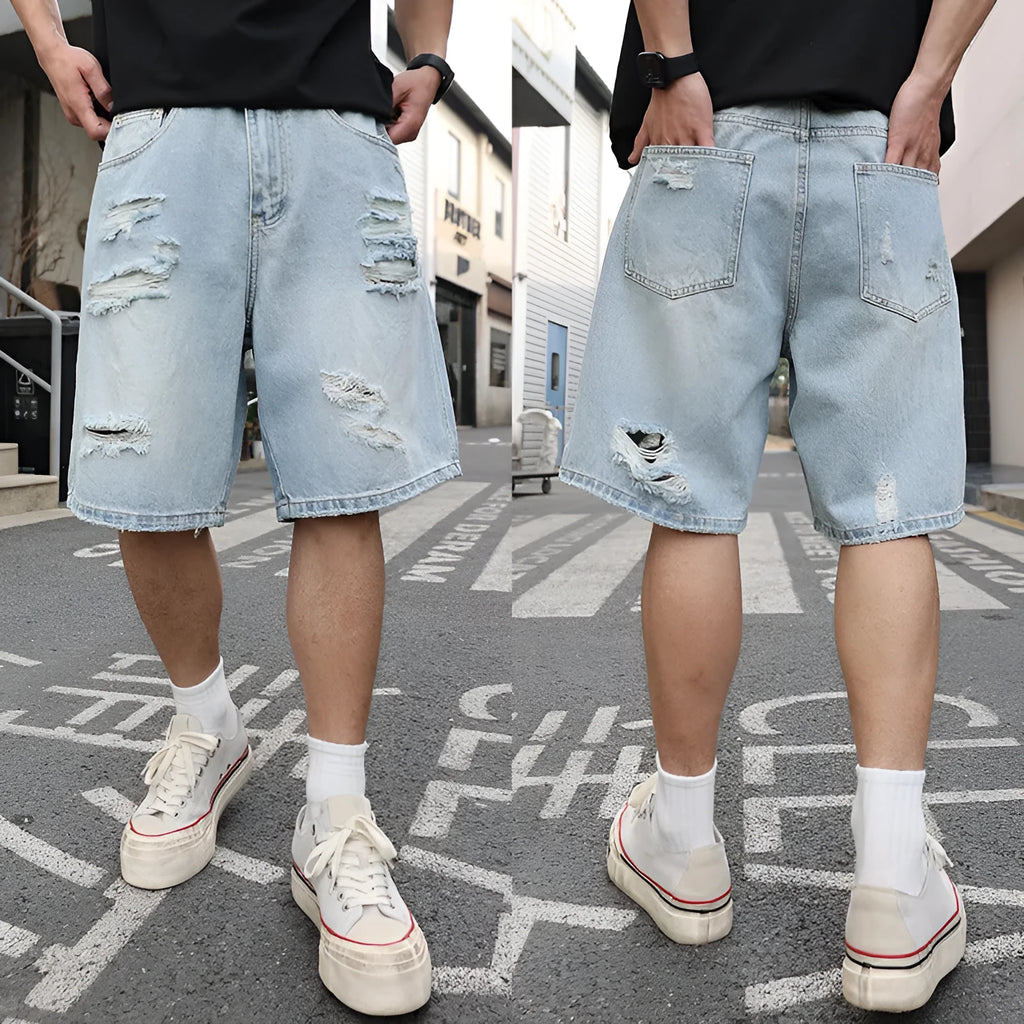 Light blue loose-fit distressed denim shorts with ripped details and straight-leg design