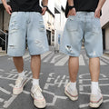 Light blue loose-fit distressed denim shorts with ripped details and straight-leg design