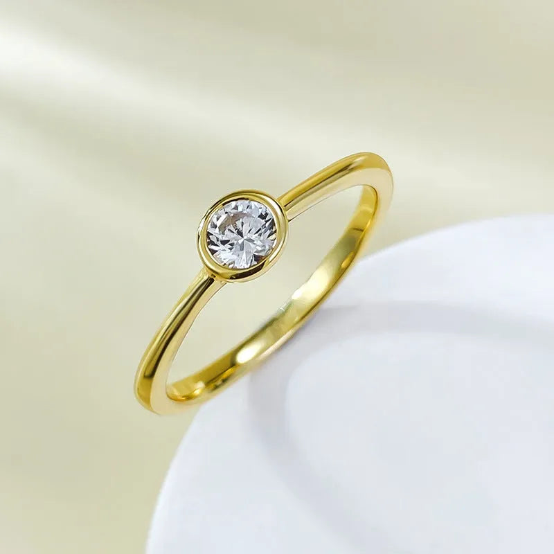 Minimalist crown-shaped silver ring with line detailing on a white background.