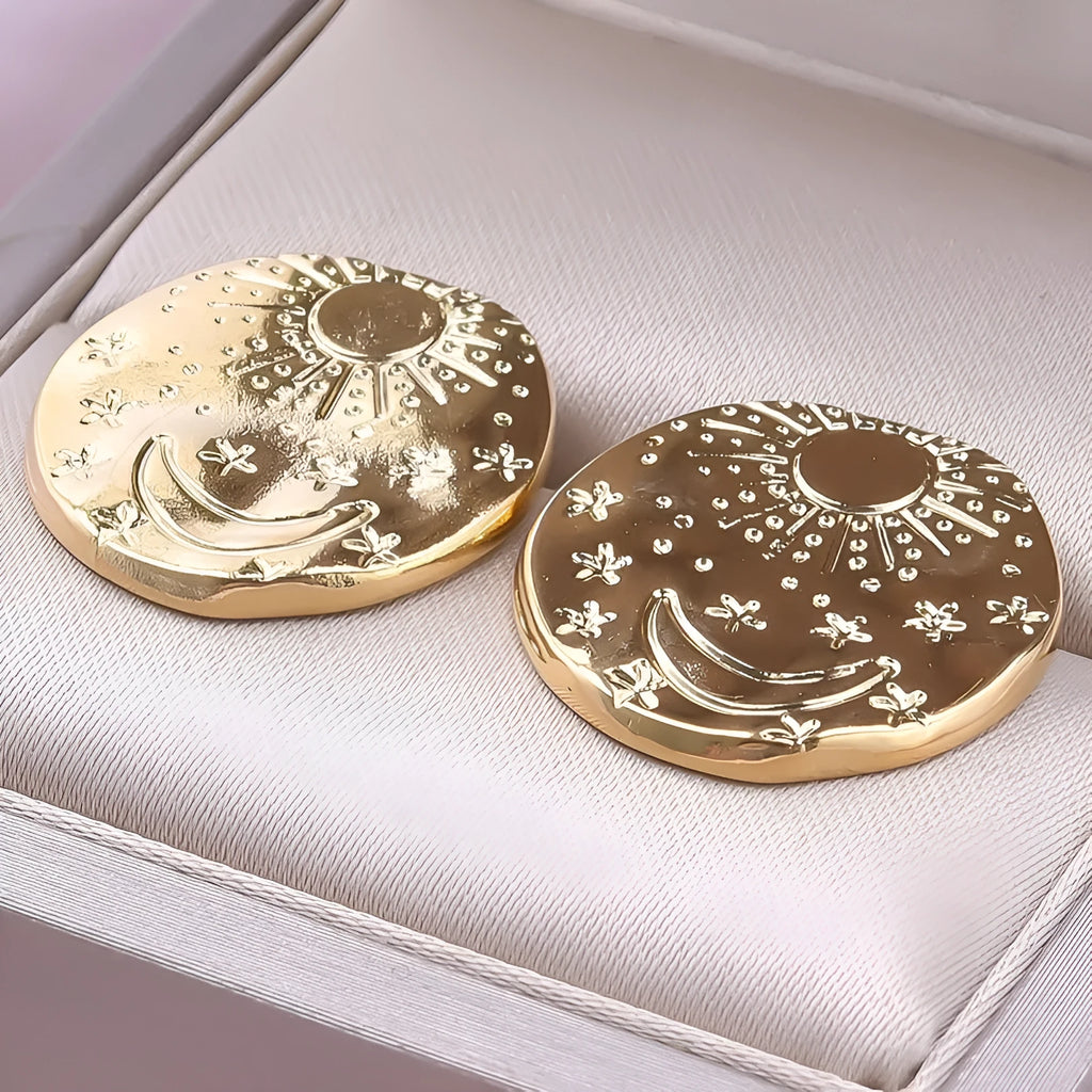 A pair of geometric shell design stud earrings in stainless steel with gold or silver plating