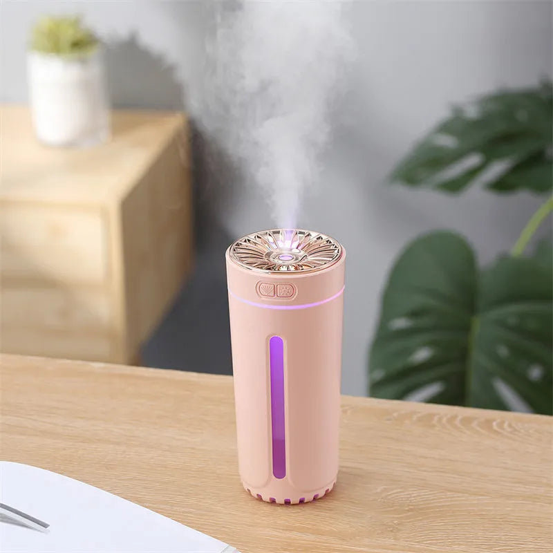 Black wireless ultrasonic humidifier with LED lights sitting in a car cup holder.
