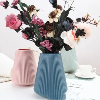 Colourful melamine plastic decorative flower vase measuring 16x20cm on desktop