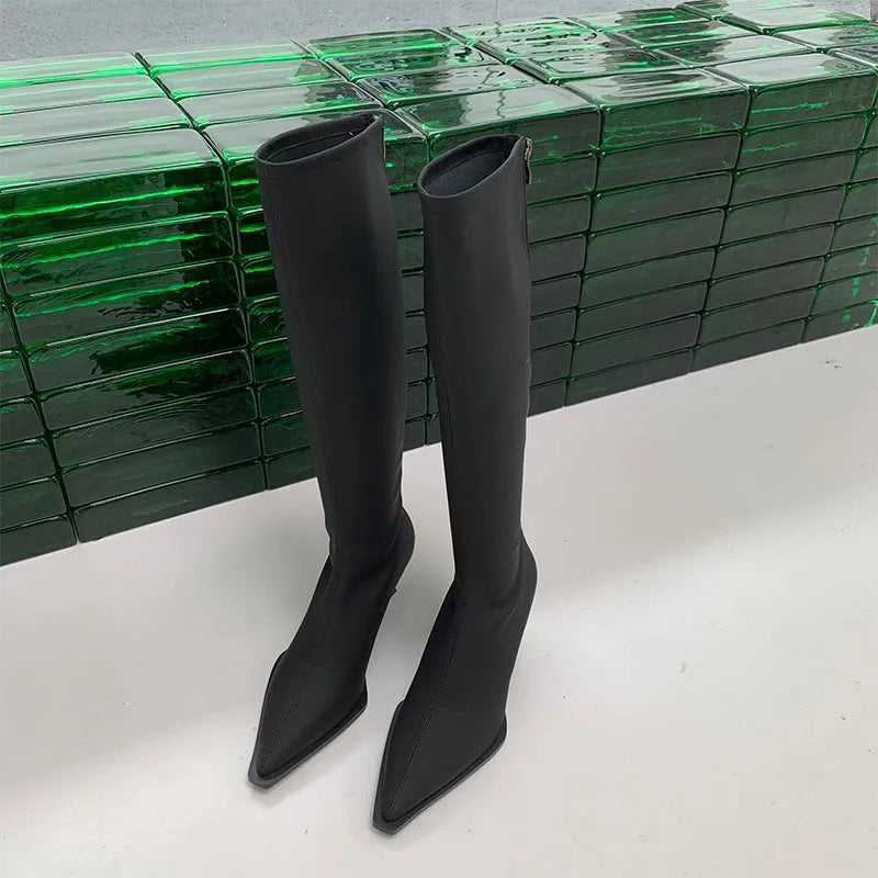 Black pointed toe women's below knee stiletto boots with a back zipper closure.